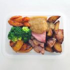 In a tray, mild cured ham basted with a mustard, clove and brown sugar glaze, baked until golden brown and moist on the inside. Accompanied by roasted pumpkin, carrots and chat potatoes, as well as steamed broccoli. Served with tangy pineapple chutney.