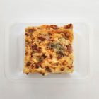 Pasta Bake, containing tender roasted pieces of chicken, crispy bacon and broccoli in a creamy parmesan sauce, topped with melted cheese in a meal tray.