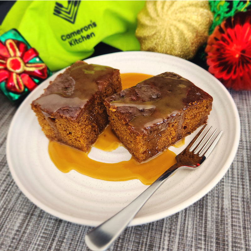 Camerons Kitchen - Sticky Date Pudding Rich sticky date pudding, served warm with a silky butterscotch sauce that cascades over each slice, creating the perfect comforting classic dessert.